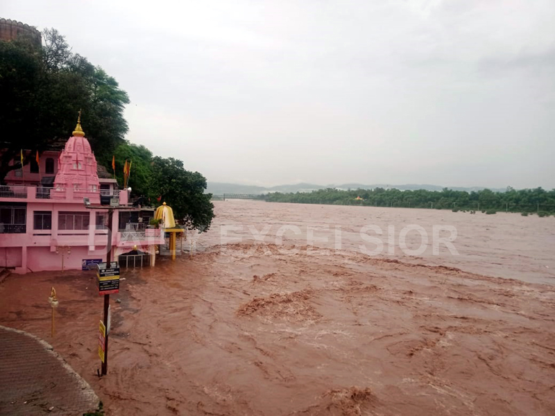 Flooded Chenab river flowing above danger mark at Akhnoor on Thursday. -Excelsior/Rakesh