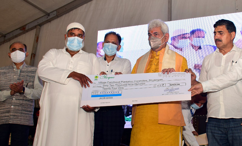 LG presenting cheque to Village Panchayat Plantation Committee.