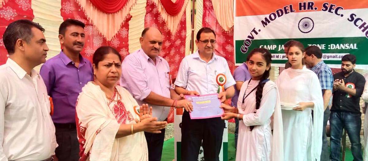 Joint Director, HR Pakhroo awarding a meritorious student in presence of others at Jagti Camp in Nagrota.