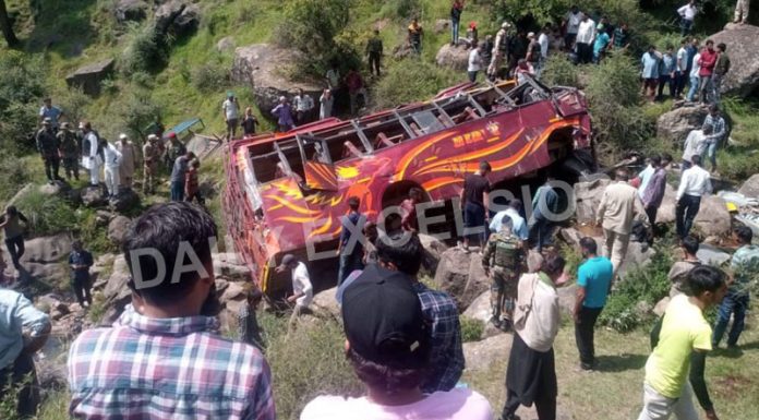 People rescue passengers as bus falls into gorge near Bhimber Gali in Rajouri on Thursday. -Excelsior/Gafoor Bhat