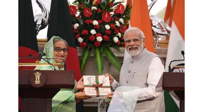 Bangladeshi Prime Minister Sheikh Hasina presenting a book to Prime Minister Narendra Modi after their meeting at Hyderabad House in New Delhi on Tuesday. (UNI)
