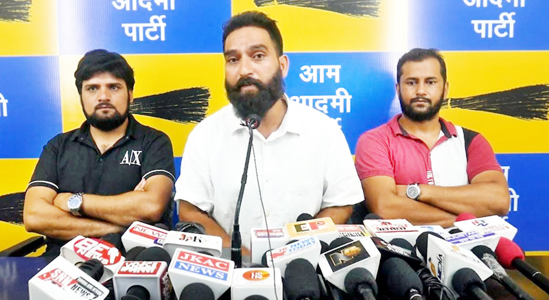 AAP leader Mehraj Malik addressing a press conference at party office in Jammu.