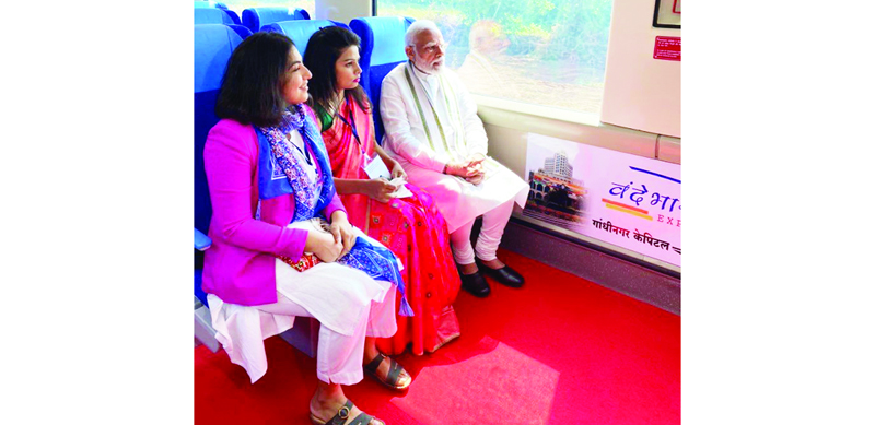 Prime Minister Narendra Modi travelling from Gandhinagar to Ahmedabad in the Vande Bharat Express train and interacting with railway workers, women entrepreneurs, youths and other passengers, in Gandhinagar on Friday. (UNI)