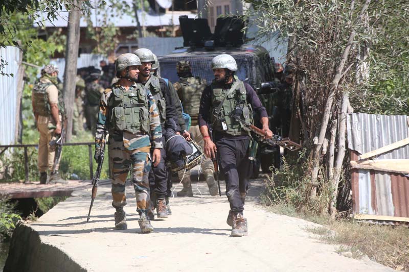 Security forces during an encounter in Yadipora area of Pattan in Baramulla district on Friday. -Excelsior/Aabid Nabi
