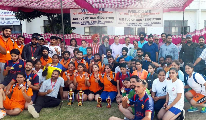 Winners displaying medals and trophies while posing for a group photograph at Jammu on Tuesday.