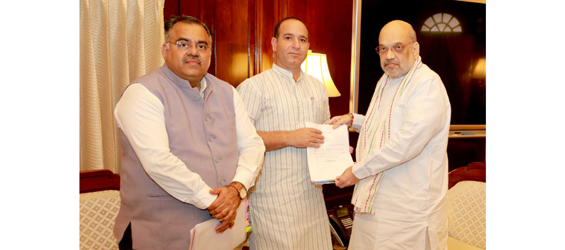 BJP general secretary J&K and former Minister, Sunil Sharma giving a memorandum to Union Home Minister, Amit Shah at New Delhi on Saturday. BJP national general secretary, Tarun Chugh is also seen in the picture.