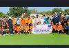 Players posing for a group photograph at KK Hakku Stadium in Jammu on Monday.