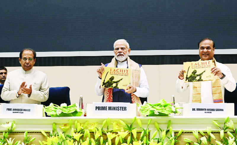 Prime Minister Narendra Modi with Assam Chief Minister Himanta Biswa Sarma releases a book based on Ahom General Lachit Barphukan at the valedictory function on his 400th birth anniversary, as State Governor Jagdish Mukhi looks on, in New Delhi on Friday. (ANI Photo)