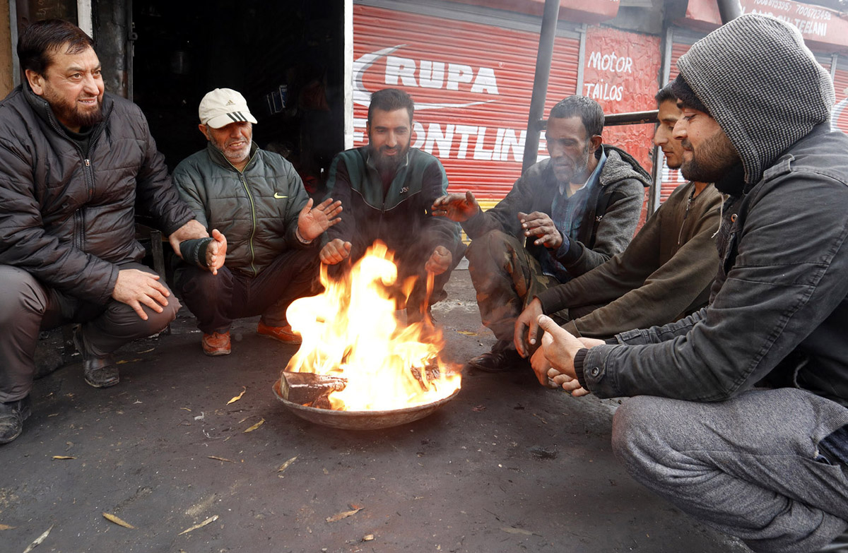 People warm themselves on a cold morning day in Srinagar. -Excelsior/Shakeel
