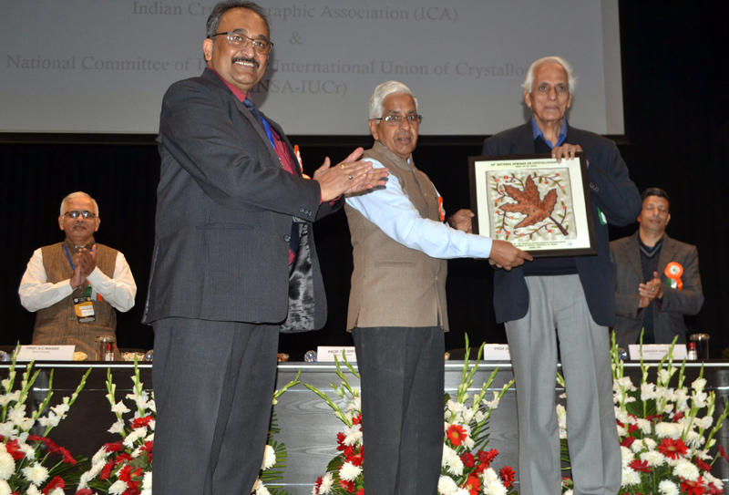 JU VC presenting a memento to guest during inaugural of 3-day seminar on Monday.
