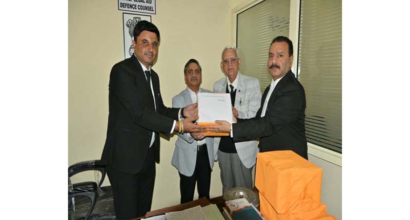 Justice Sanjeev Kumar handing over law books to CDC Jammu Anil Sharma in presence of AG J&K and Ladakh DC Raina.