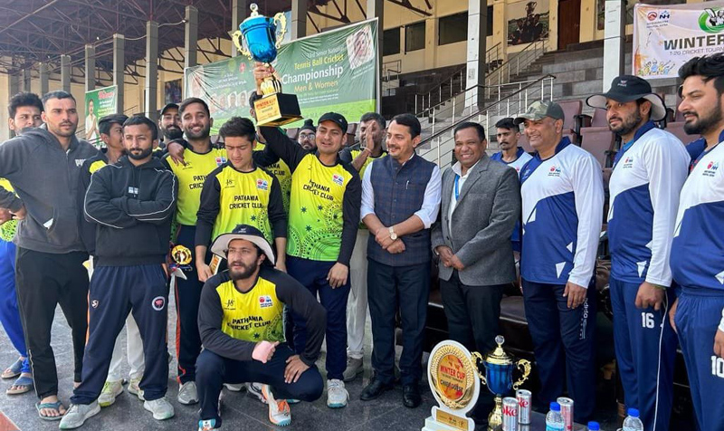 Players displaying the winning trophy while posing with dignitaries at MA Stadium Jammu on Wednesday.