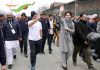 Rahul Gandhi and Priyanka wave at crowd as they lead Bharat Jodo Yatra in Kashmir on Saturday.