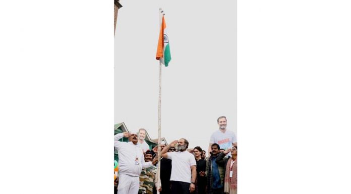 Congress leader Rahul Gandhi and others salute tricolor after hoisting it at Lal Chowk in Srinagar on Sunday.