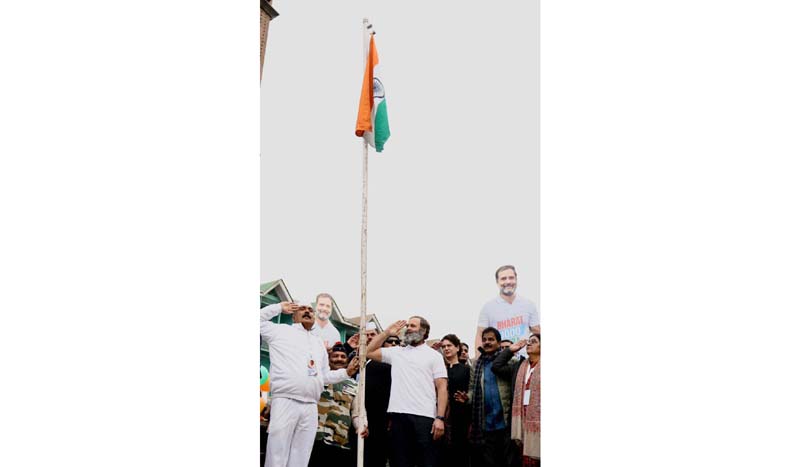 Congress leader Rahul Gandhi and others salute tricolor after hoisting it at Lal Chowk in Srinagar on Sunday.