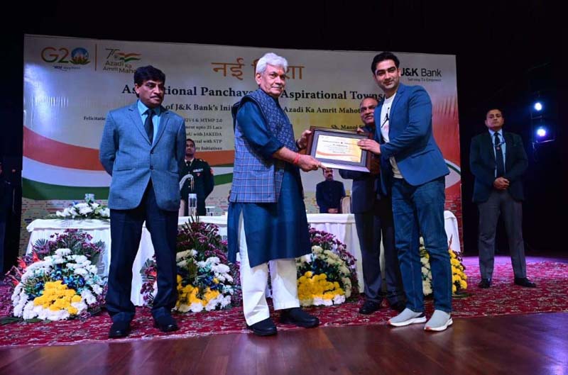 Lt Governor Manoj Sinha felicitating youth selected for self employment.