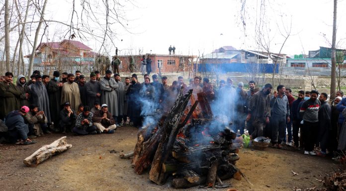 Hundreds of local Muslims participating in last rites of Sanjay Sharma at his native village in Achan , Pulwama on Monday. -Excelsior/Younis Khaliq