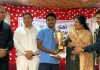 A guest presenting trophy to a winner of MPL National Blitz Chess Championship in Jammu.
