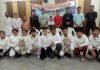 Winners displaying trophies while posing for a group photograph at Reasi on Wednesday.