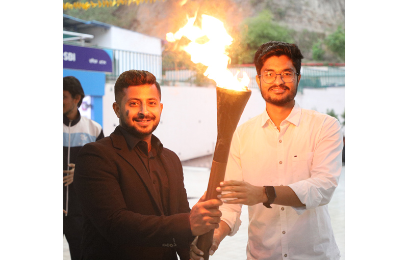 Cricketer Shubham Khajuria presenting torch to a student during the commencement of Sports Festival at IIT Jammu on Friday.