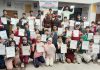 Winners displaying certificates at Pulwama on Sunday.