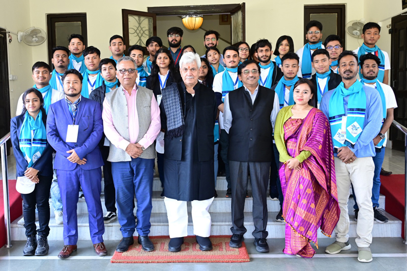 LG Manoj Sinha with students from Assam posing for a group photograph.