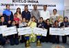 Winners of various categories of bouts of Khelo India Sub Junior Women's Wushu League displaying certificates and trophies while posing with dignitaries.