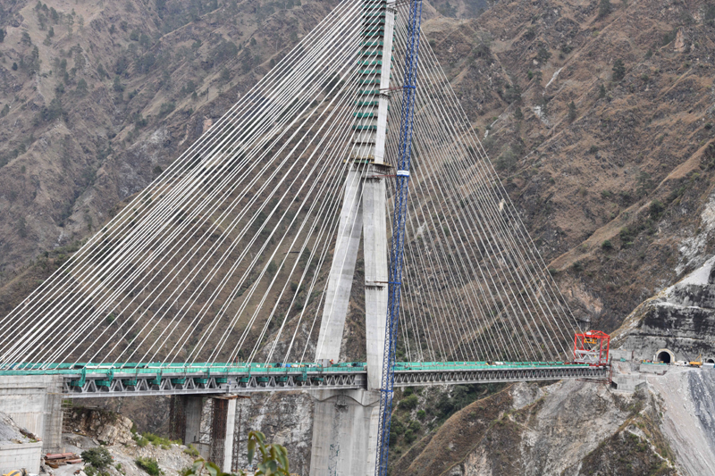Construction work underway at Anji Khad bridge, India’s first cable-stayed raliway bridge, during a media preview in Reasi district on Sunday. (UNI)