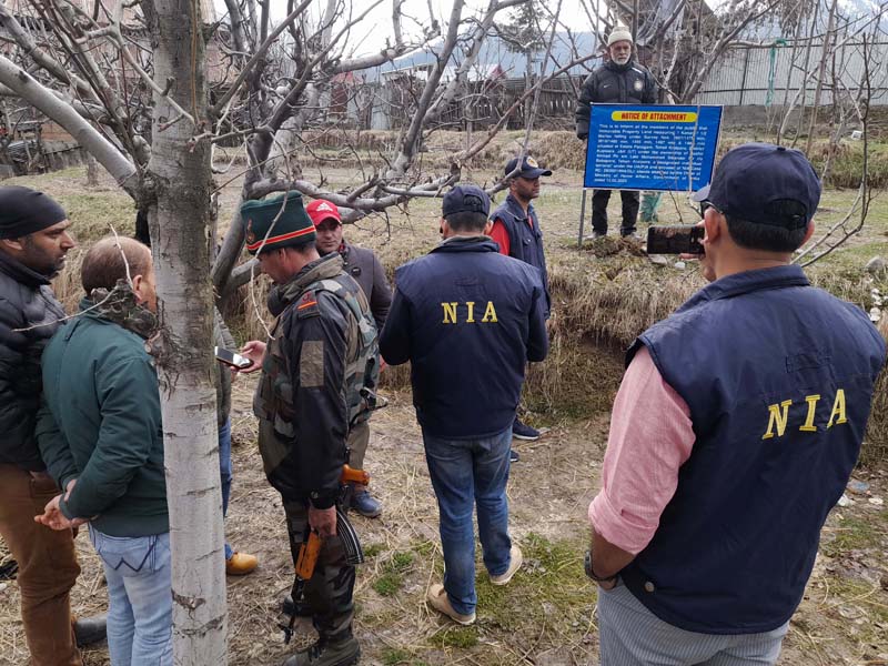 NIA team attaches property of HM militant in Kupwara on Saturday. -Excelsior/Aabid Nabi