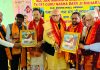 Mayor Jammu, Rajinder Sharma and Deputy Mayor, Baldev Singh Billawara being presented portrait of Guru Naba Dass Ji by the organizers of function at Jammu on Sunday.