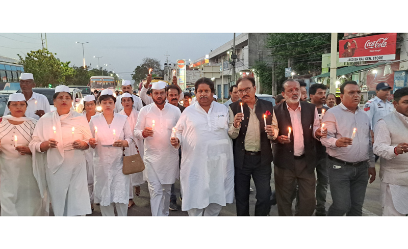 Cong leaders and Sewa Dal activists taking out candle light march in support of Rahul Gandhi in Jammu.