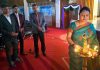 A dignitary lighting ceremonial lamp during a programme at PSPS Govt PG College for Women, Gandhi Nagar.
