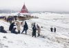 Tourists enjoying fresh snowfall in Gulmarg. - Excelsior/Aabid Nabi