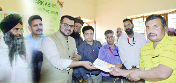 Deputy Commissioner Poonch handing over cheque to a farmer.