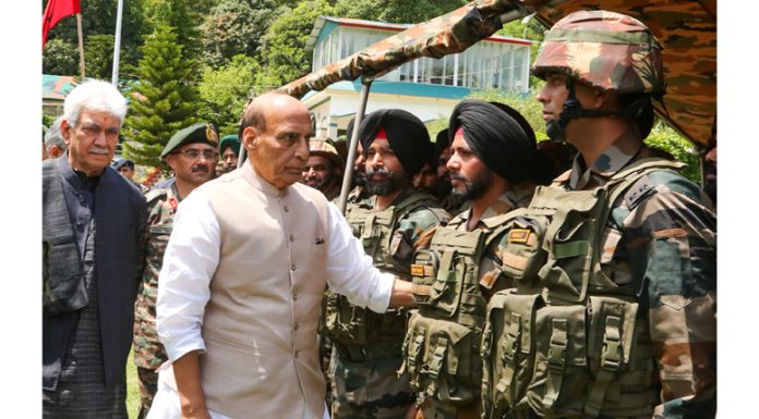 Defence Minister Rajnath Singh accompanied by LG Manoj Sinha interacting with troops at Rajouri on Saturday.