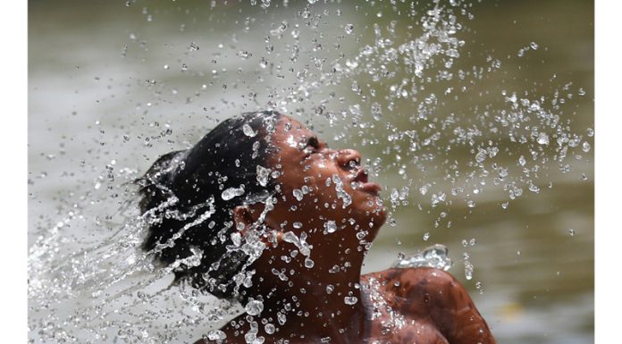 A boy enjoys bath in Ranbir canal on a hot summer day in Jammu. -Excelsior/Rakesh