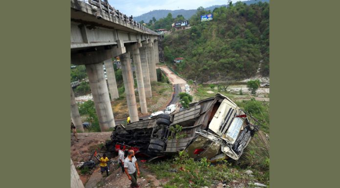 The ill-fated bus that met wtih an accident lying upside down at Jhajjar Kotli area of Jammu on Tuesday. -Excelsior/Rakesh