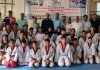 Winners of Inter School J&K Taekwondo Championship posing with guests during closing ceremony in Jammu.