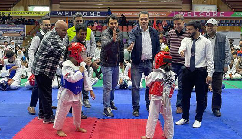 Little Taekwondo players in action during a bout at Sher-e-Kashmir Indoor Sports Complex, Srinagar.