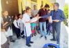 SDM Virender Gupta distributing sports material among students in the Chowki Choura area on Friday.
