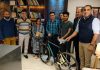 ADGP Armed J&K SJM Gillani handing over a racing cycle to professional racer of Jammu Manav Padha.