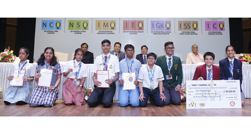 Olympiad winners posing with their certificates.