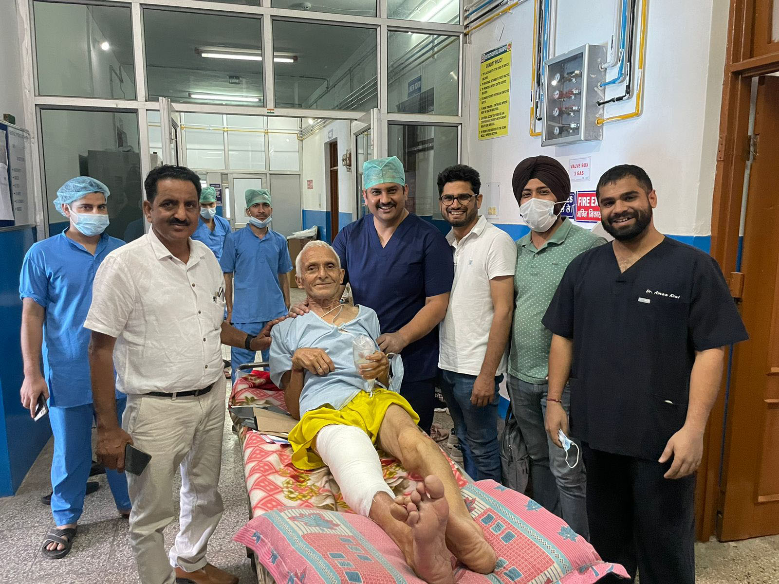 Dr Balvinder Singh and his team of doctors posing with a patient on whom they performed total knee replacement surgery.