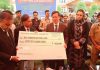 Chief Justice, High Court J&K, N Kotiswar Singh presenting cheque to a beneficiary on Saturday.
