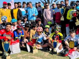 Secretary J&K Sports Council, Nuzhat Gul along with cyclists posing for group photograph during function at Budgam.