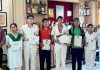Students of DPS displaying certificates while posing for a group photograph.