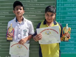 Abhirath Thappa and Saksham Amla of DPS displaying certificates & medals while posing for photograph.
