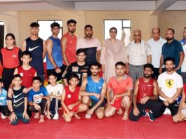 Secretary Sports Council, Nuzhat Gull posing for a group photograph with athletes in Jammu.
