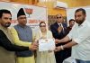 MP Gulam Ali Khatana along with Waqf Board Chairperson Dr Darakhshan Andrabi presenting certificate of honour to a media person during an event in Baramulla.