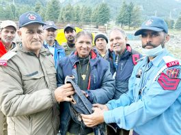 ASI Darshan Kumar and HC Satpal handing over the lost bag to its rightful owner in Kashmir on Sunday.